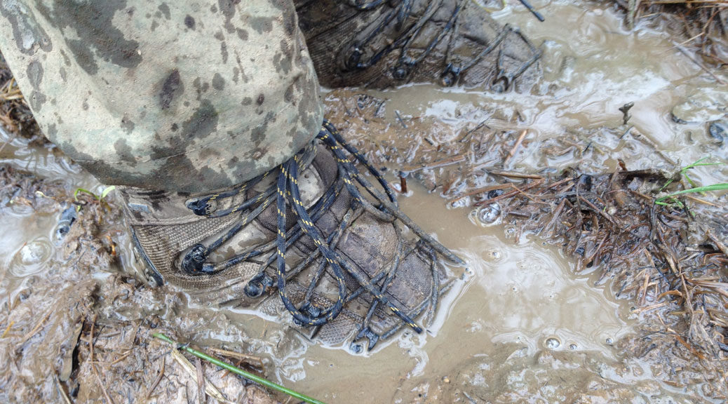 walking boots in muddy water